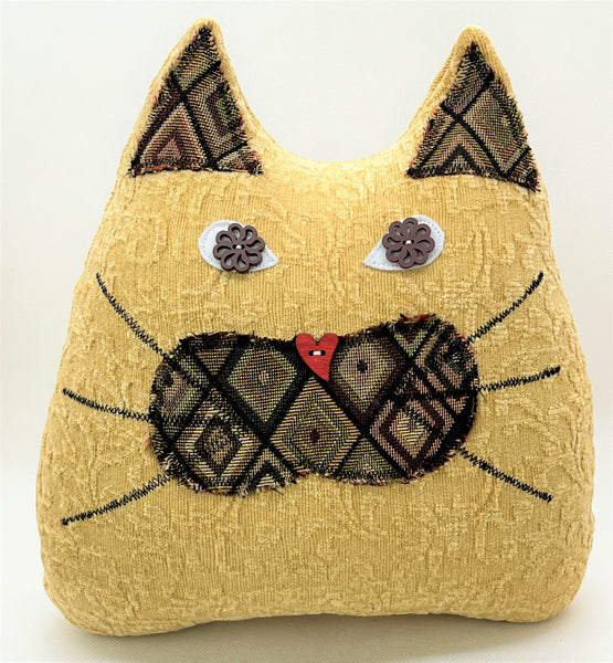 Beige cat pillow with neutral diamond print in shades of brown