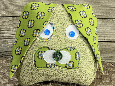 Green bunny pillow with navy medallion accent fabric