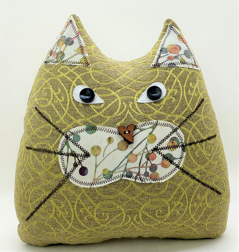 Taupe and green cat pillow with multicolor batik print