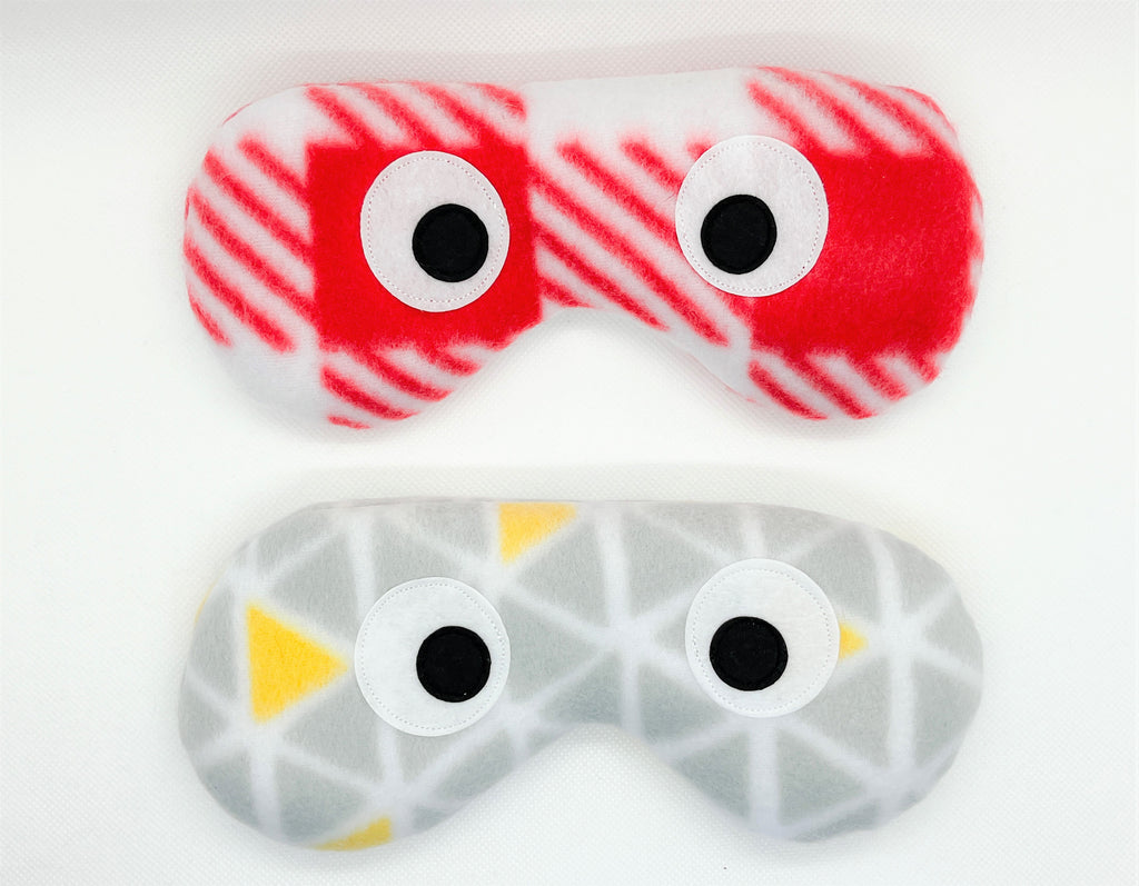 eye masks in red and white plaid and gray and yellow geometric prints