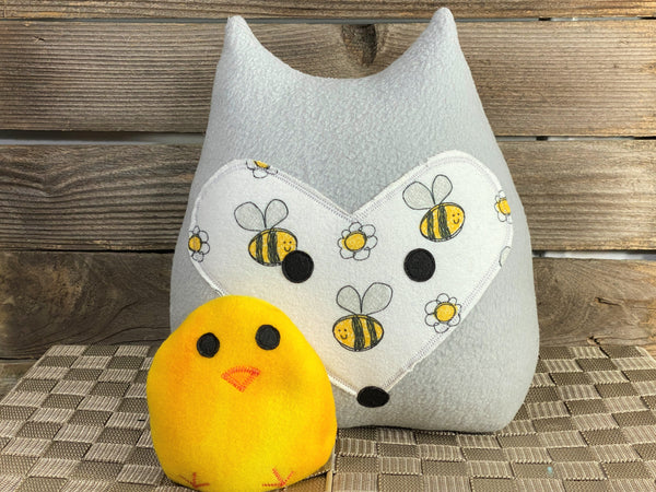 Gray fox pillow with a bumblebee print and a yellow chick hot and cold pack