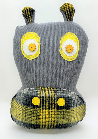 gray hippo pillow with black gray and yellow plaid accents