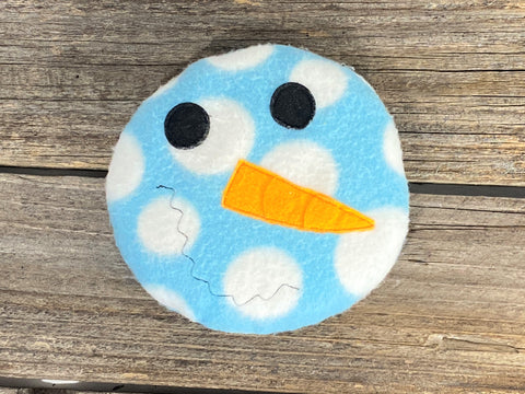 Blue and white dotted snowman face for use as a hot or cold pack