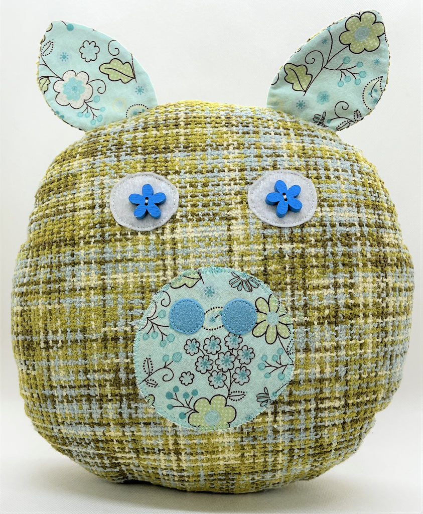 pig pillow in shades of blues and greens