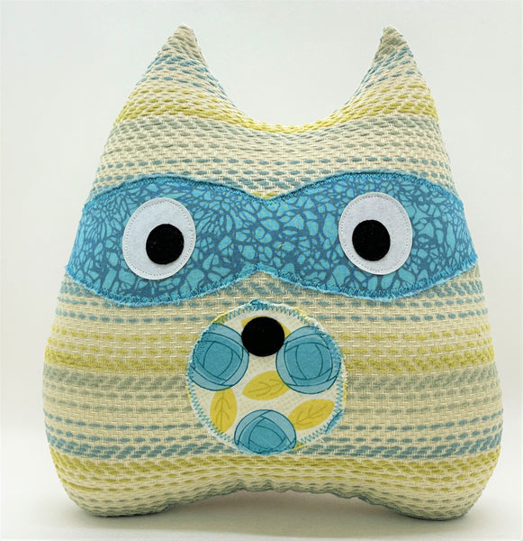 striped raccoon pillow in shades of teal blue and yellow
