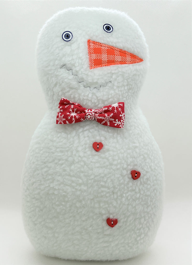 Snowman pillow with red and white bowtie and red heart buttons